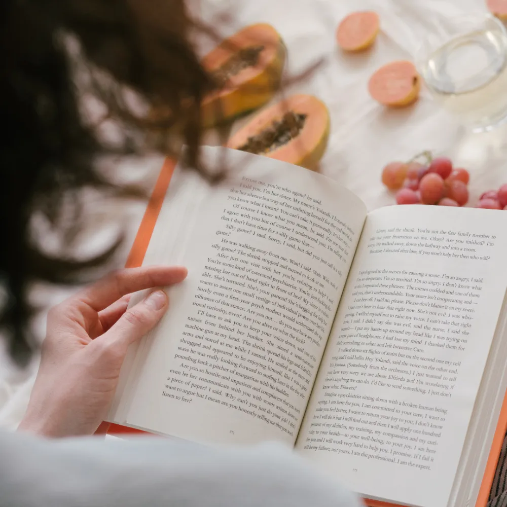 A photo of a woman reading a book.